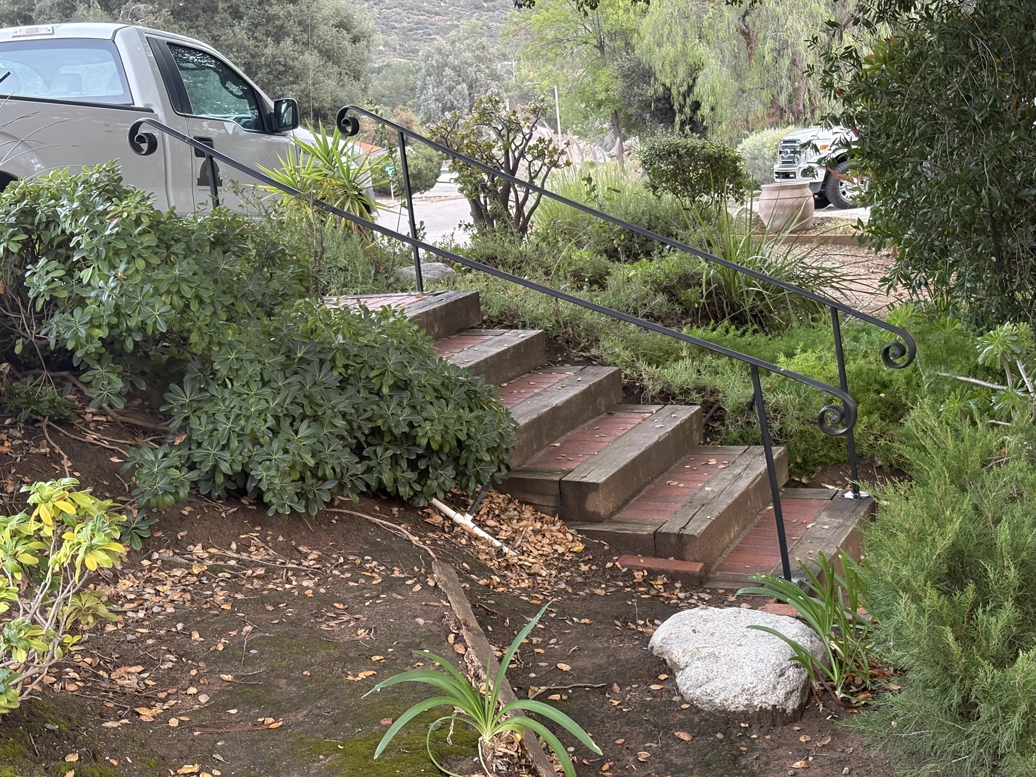 Custom welded handrail with scroll details on steps