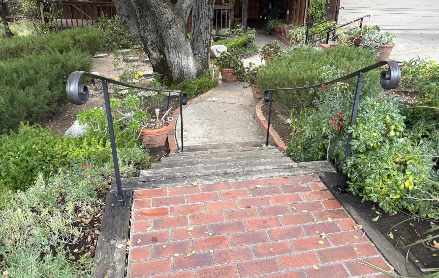 Finished black metal railing on garden steps